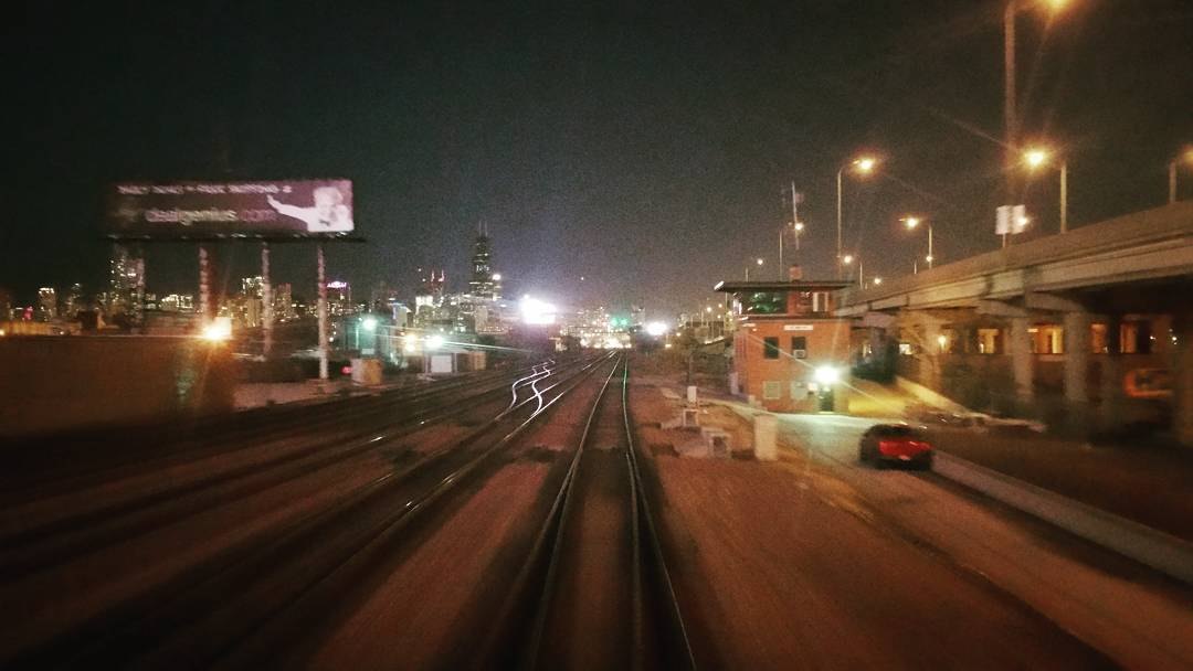 Train tracks running into the Chicago Loop at night, Willis Tower ahead